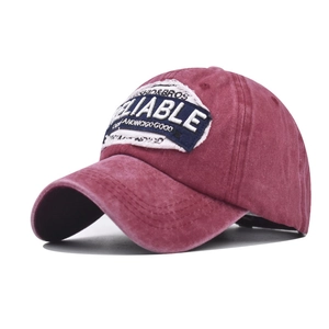 Vintage washed wine red baseball cap with embroidered Reliable patch shown at 45-degree angle