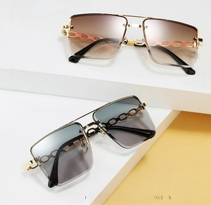 Detail of square rimless sunglasses with gold chain temples and gradient lenses