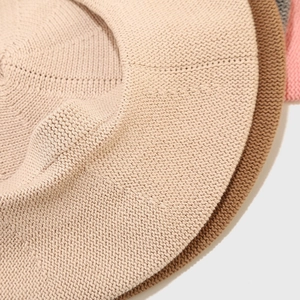 Classic knitted cotton beret hat in solid beige and camel colors with fine stitch detail