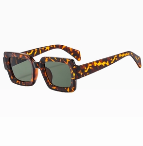 Close-up of tortoise shell square frame sunglasses with thick temples and dark lenses