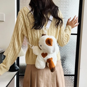 Cute white plush calico cat crossbody bag with brown heart spots worn by a model