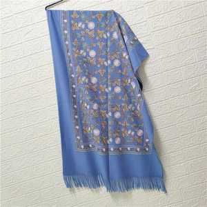 Detailed embroidery with floral patterns and soft tassels on blue cashmere-feel shawl scarf