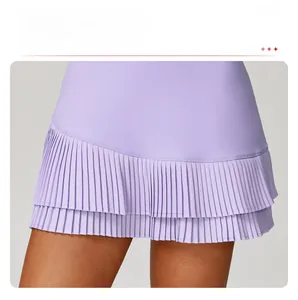 Detail view of the light purple pleated hem and layered sporty design of this athletic skirt