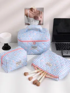 Blue gingham quilted cosmetic bag set with pink bows featuring three travel organizers