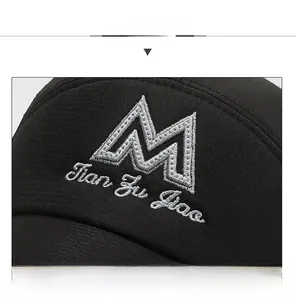 Close-up of premium black baseball cap featuring detailed white 3D embroidery of letter M