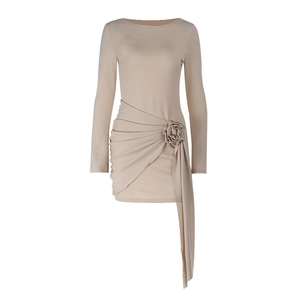 Close-up of textured beige dress featuring 3D flower detail and waist ruching design