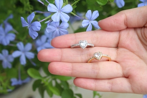 Close-up of heart-shaped zircon rings with micro-pave diamonds in gold and silver
