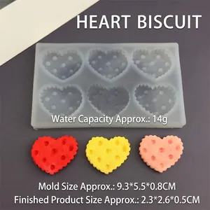 Detail view of 6-cavity heart silicone mold with dimensions and colorful finished cookies