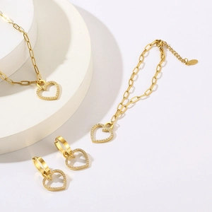 Golden titanium steel jewelry set featuring CNC heart pendants with micro-pave crystals