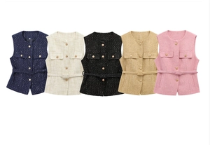 Detailed view of tweed sleeveless vests in five colors with metallic buttons and belts