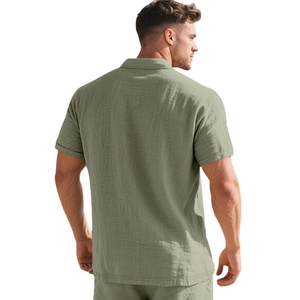 Close-up of sage green textured linen fabric on the back of a men's polo short sleeve shirt