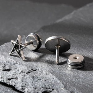 Men's stainless steel stud earrings with star and round geometric shapes on stone background
