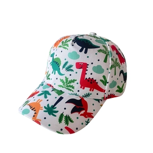 Close-up of kids baseball cap with colorful dinosaur prints and green palm leaf patterns