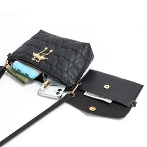 Quilted heart pattern crossbody bag set with gold wing charm and interior storage view