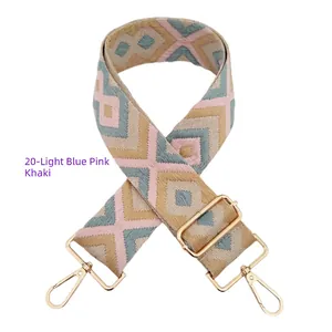 Detail of embroidered geometric diamond strap with golden metal swivel hooks