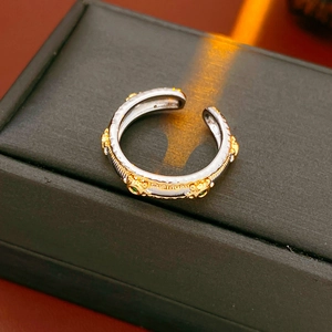 Detail of vintage oval adjustable ring with green gemstone on a black jewelry box
