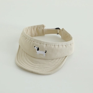 Detail of beige sun visor cap with cute dog embroidery and adjustable black buckle