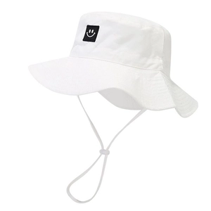 Detail of white kids sun hat featuring a smiley face patch and adjustable chin strap