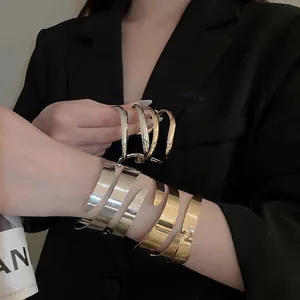 Minimalist double-layered geometric open cuff bracelet set in polished gold and silver finish