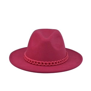 Rose red fedora wool hat with matching chain trim on minimalist white background