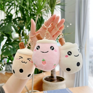Three cute plush boba tea keychain charms in brown, pink and white colors