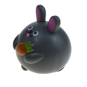Detail of round grey bunny toy holding a carrot with smooth plastic finish