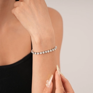 Minimalist silver tennis bracelet with cubic zirconia stones worn on the wrist