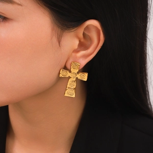 Vintage golden cross earrings with spiral texture for women in a luxury aesthetic