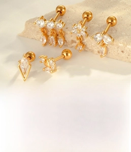 Detailed view of gold diamond rhombus cartilage studs with titanium steel screw backs