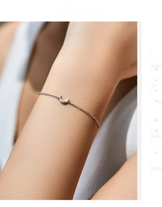 Macro detail of minimalist S925 sterling silver crescent moon pendant on a fine link chain