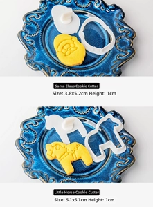 Detail of Santa and pony cookie cutters with precise dimensions on a blue plate