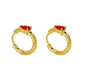 Detail view of golden water drop earrings with red pear-cut zircon stones and smooth finish