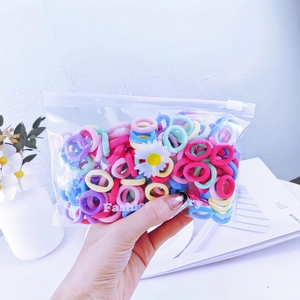Detailed view of colorful elastic hair ties in a frosted daisy zipper pouch