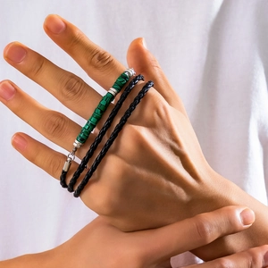 Close-up of men's layered braided rope bracelet with turquoise beads on a model wrist