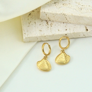 Elegant 14K gold plated stainless steel hoop earrings with shell pendants on travertine