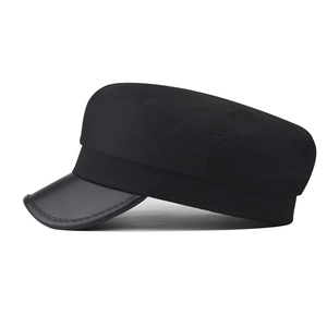 Classic black newsboy cap featuring a cotton crown and a faux leather brim on white background