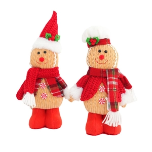 Pair of festive gingerbread man plush dolls with red hats for Christmas home decor