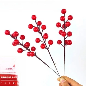 Detail of lifelike red artificial berries with vibrant round fruit for festive decor