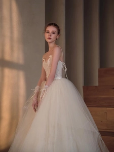 Detail of elegant lace bodice and layered tulle skirt on a vintage French wedding dress