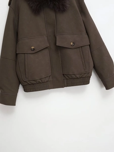 Close-up of brown faux leather jacket featuring a plush purple fur collar and utility pockets