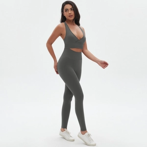 Detail of dark grey seamless crossover sports bra and high-waisted yoga leggings set