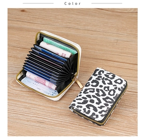 Detail view of leopard print card holder featuring accordion slots and golden zipper
