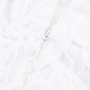 Detailed view of invisible zipper closure on white lace French style two-piece dress set