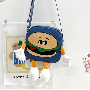 Detail of blue canvas messenger bag with a 3D cartoon hamburger and plush arms and legs