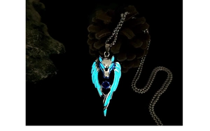 Close-up of wolf head pendant with blue luminous glow and center gemstone on metal chain