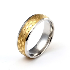 Detail of 6mm two-tone titanium steel ring featuring gold checkered pattern and polished finish