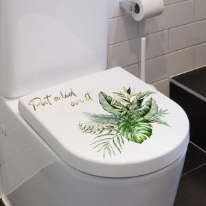 Detail of tropical green leaf decals and Put a lid on it text on white toilet lid