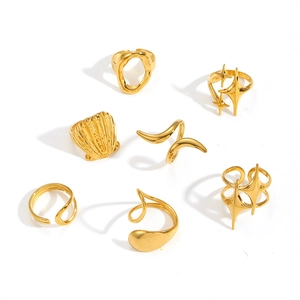Set of 7 gold geometric stainless steel rings with celestial star and organic designs