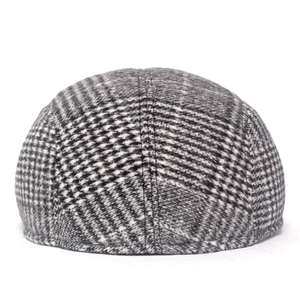 Detailed back view of houndstooth plaid wool newsboy cap with multi-panel stitching
