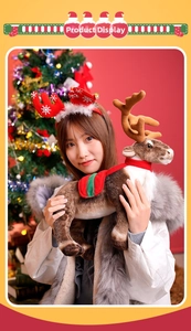 Close-up of a plush Christmas reindeer toy and red antler headband in a festive setting